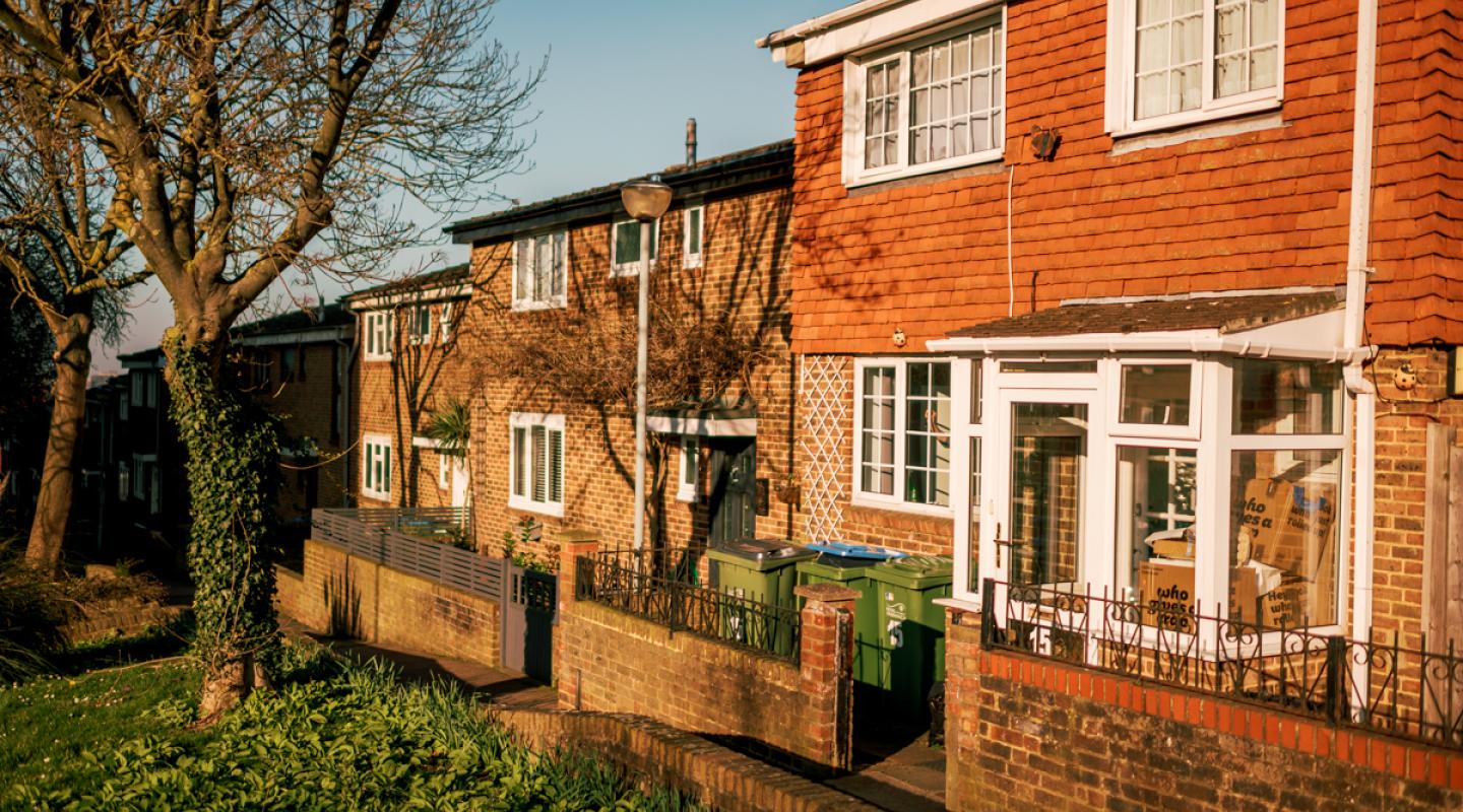 A row of brick houses, with grass in front of them