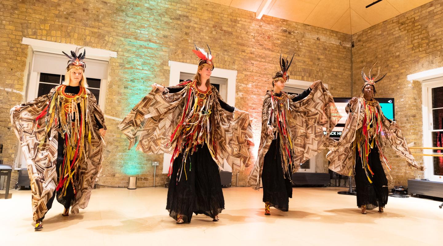 Four dancers on stilts