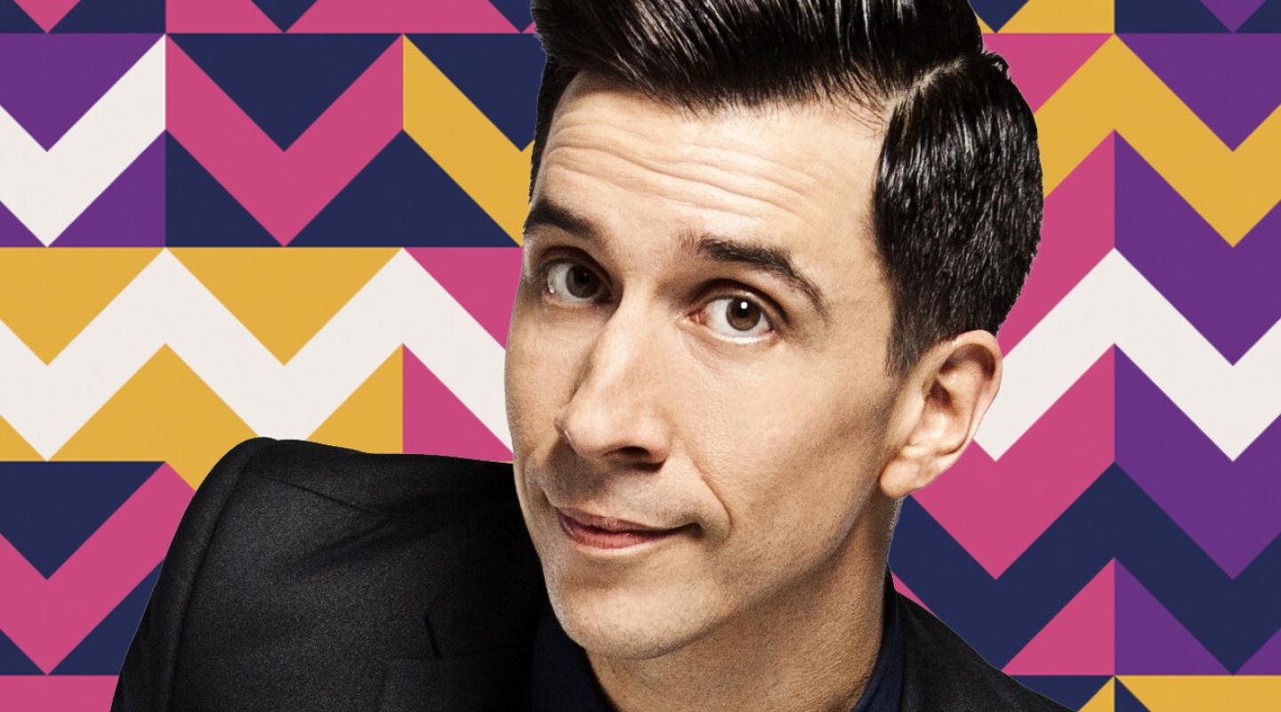 A man with short black hair looking at the camera (comedian Russell Kane)